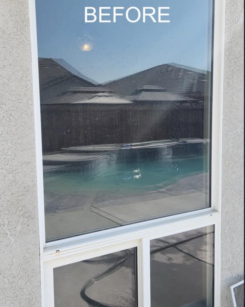 Residential window with hard water spots and grime before professional cleaning